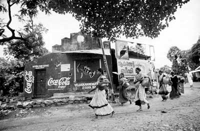 International Women's Day. The real one -- Miles of walk every single day to get water to drink and cook because Coke has took their traditional water sources. (Film star Amir Khan would not disclose it in his Coke promo. Neither would Sonia Gandhi).