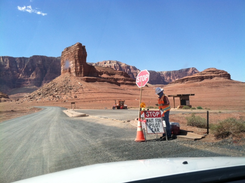This woman is guarding the new road construction near Marble Rock Canyon. She is in 110 degrees heat all day long, and her only shade is the stop sign. She calls pilot cars for tourists like us who want to go deep inside to see Lee's Ferry where whitewater rafters sail their boats on Colorado River. In July, temperature here could reach 125 degrees Fahrenheit. 