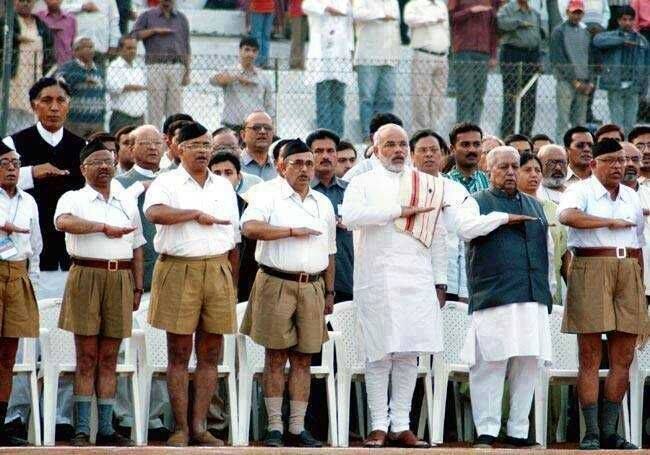 Prime Minister Modi praying at RSS meeting. U.S. once revoked his visa, but that was before he became a friend of Obama, Clinton, and Wall Street.